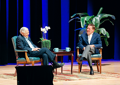 Hugh McColl and Dr. Sparks talking on stage