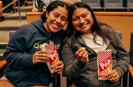 Student eating popcorn at movie night