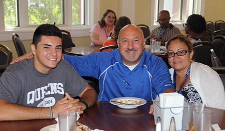 Queens student with parents in Young Dining Hall