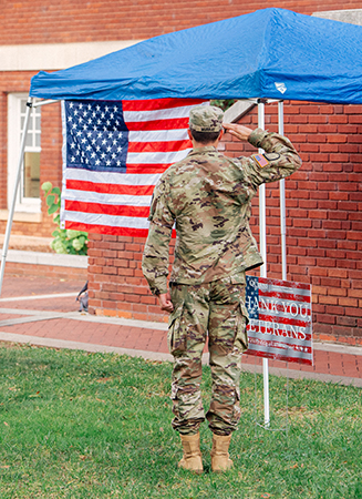 ROTC student saluting the flag