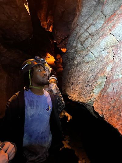 Jordan Sanders exploring a cave