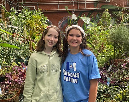 Teagan Raynor and friend in greenhouse