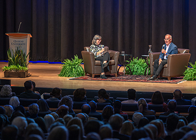 David Brooks speaking on stage to audience