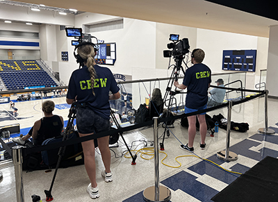 Students operating video cameras in Curry Arena