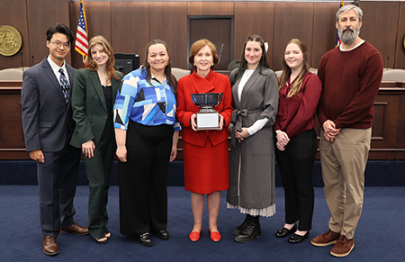 2025 Ethics Bowl team with trophy